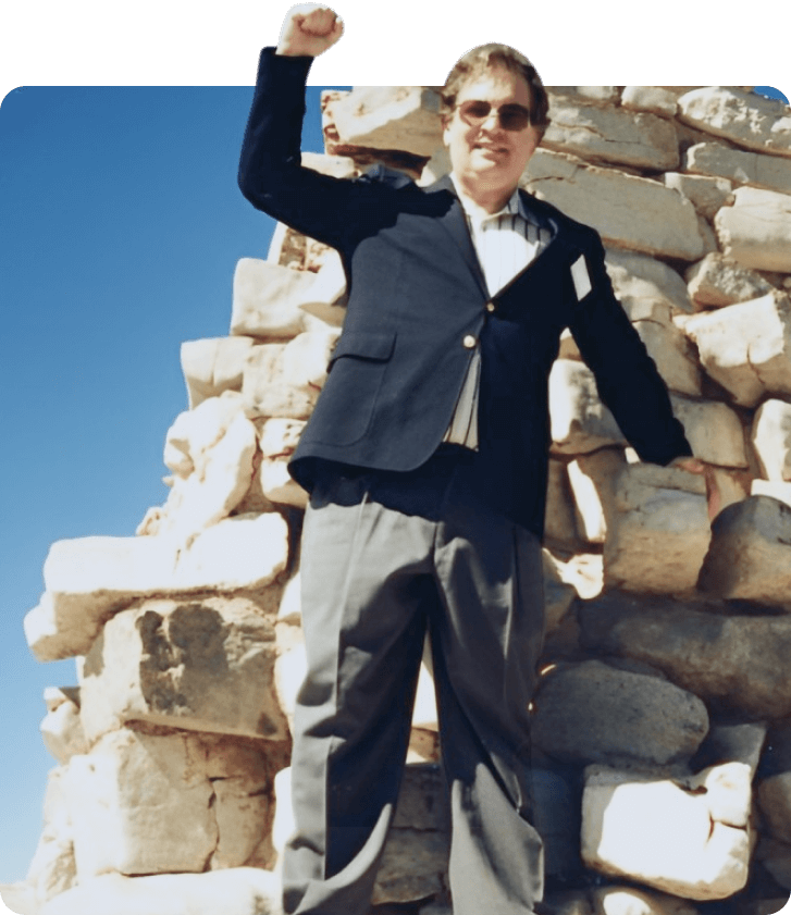 Glenn A. Mayfield standing at ancient ruins.
