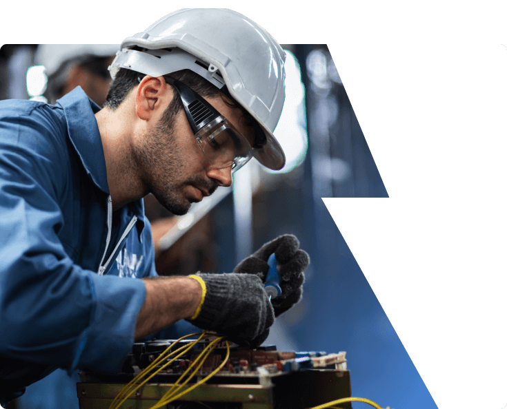 A technician working on equipment in a manufacturing facility