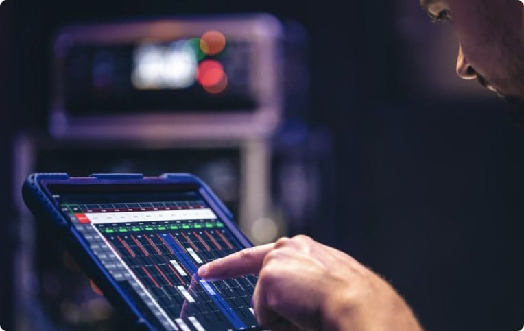 A male touching the screen of a tablet.