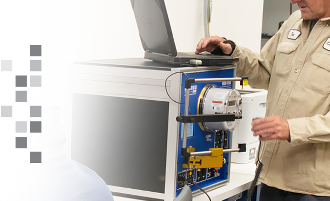 A meter technician using a WECO Test Board in a meter shop.