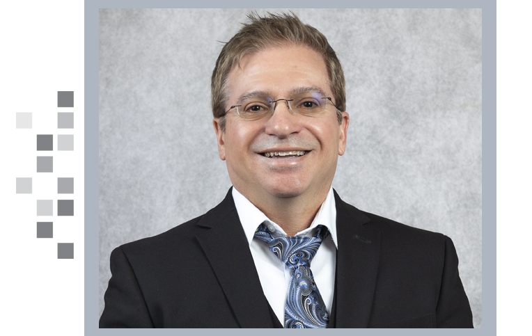 President Tim Everidge on a gray background.